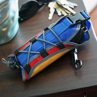 RAINKIST® Backpack Umbrella - Get maximum coverage from a mini umbrella!  Compact black umbrella in multi-colored, durable, lightweight, waterproof oxford nylon sleeve designed to look like a traditional backpack.  Clips easily to any bag for convenient carrying.